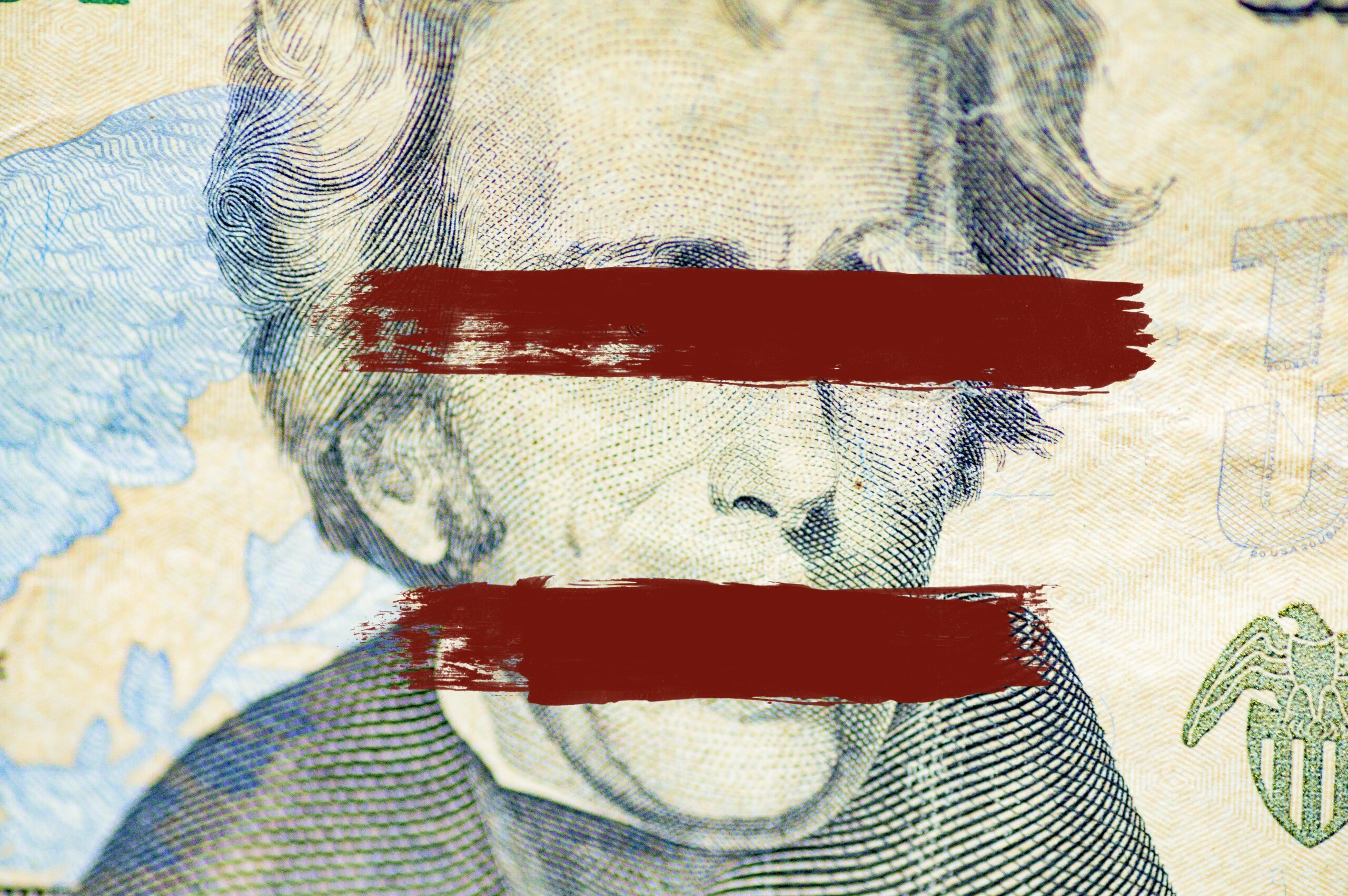 //www.freetrade4us.org/wp-content/uploads/2025/01/closeup-shot-andrew-jackson-face-dollar-bill-with-lines-painted-eyes-mouth-scaled.jpg